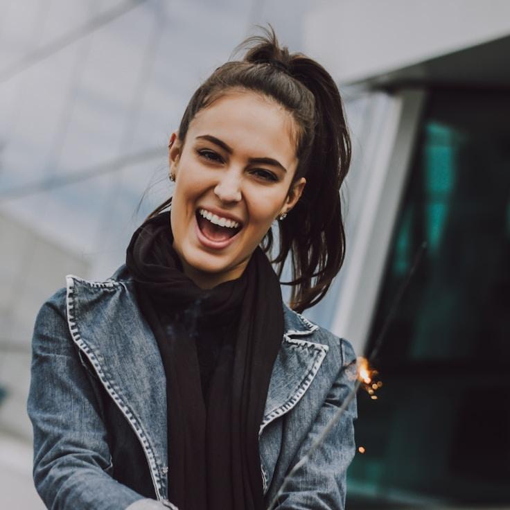 Maya Singh, Lead Design Curator at PlumeWillowMossy, reviewing corporate floral arrangements